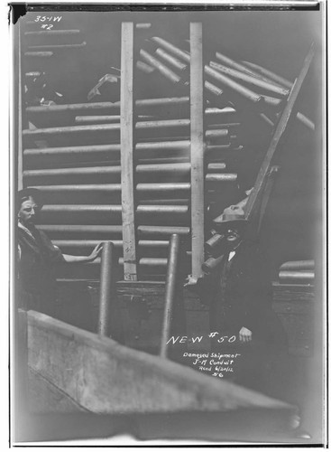 Men standing by a railcar with a damaged shipment of J-M conduit