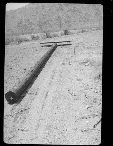 Distribution pole with assembled cross arm on ground