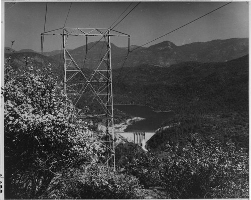 This single-circuit transmission tower stands on a hillside overlooking Dam #7 and Redinger Lake