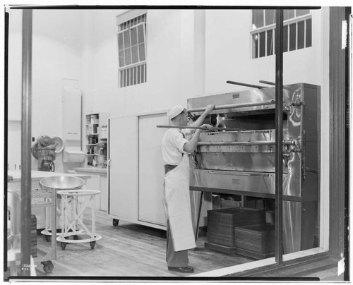 Market Spot All Electric Bakery - Man using oven