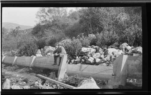 A man sitting on the side of the conduit