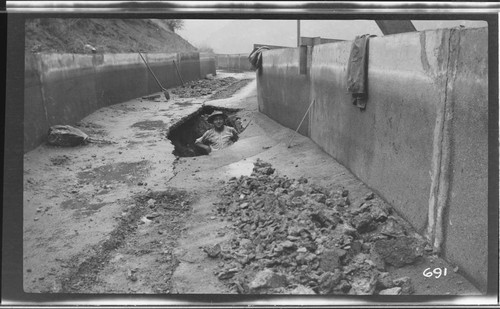 A man standing in the first break in the ditch at Kaweah #3 Hydro Plant