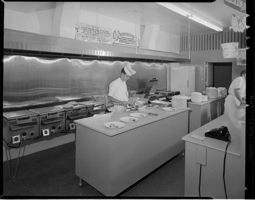 Chicken Delight take-out store with people preparing chicken dinners