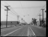 Street scenes on Santa Fe Ave. at 38th Street with electric rail and street lighting