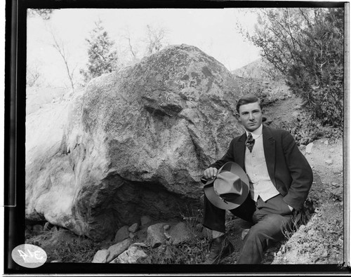 Man leaning up against the rocks