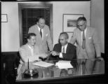 Men signing documents