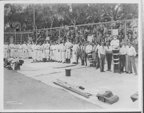 Men on a field in 6 teams involved in a first aid competition