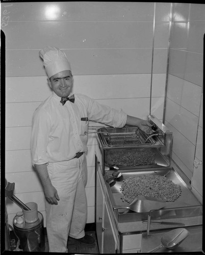 Man mixing nuts in kitchen