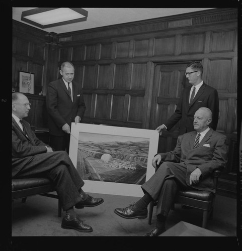 Executives seated in office with artist's drawing of the proposed San Onofre Nuclear Generating Station (SONGS)- Unit 1 project