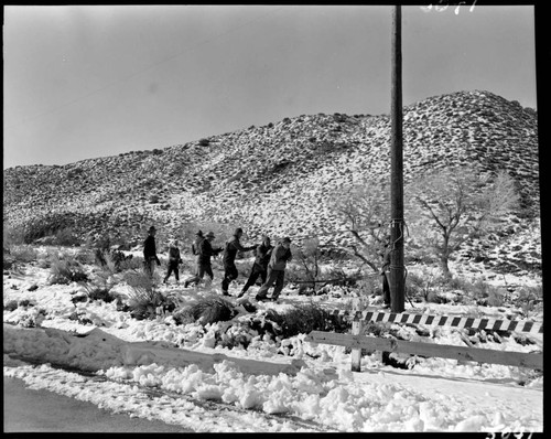 Linemen working on pole in the snow