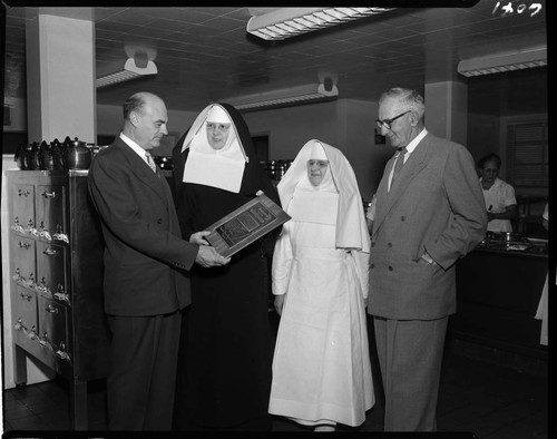 Saint Francis Hospital nuns receiving Merit Award from Institutions Magazine in hospital kitchen