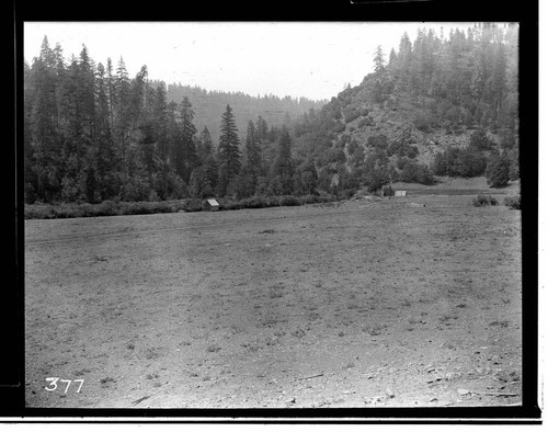 Open field with shed at edge