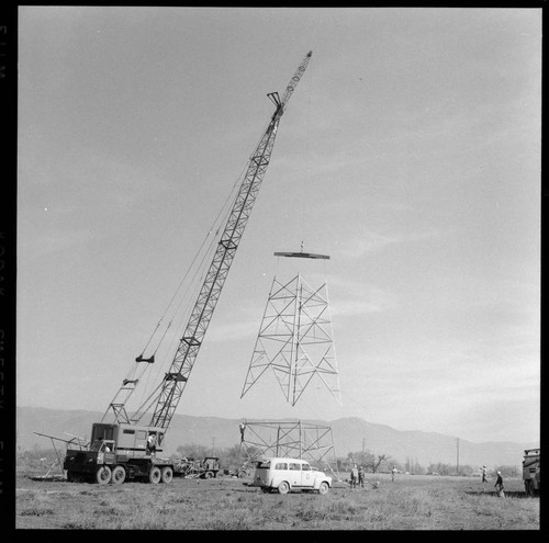 Transmission tower construction using a crane