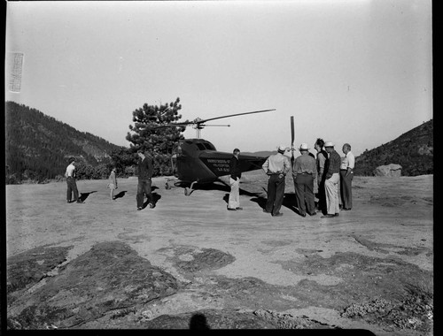 People standing around helicopter used for patrols at Big Creek in 1947