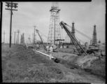 Pipe installation through an oil field