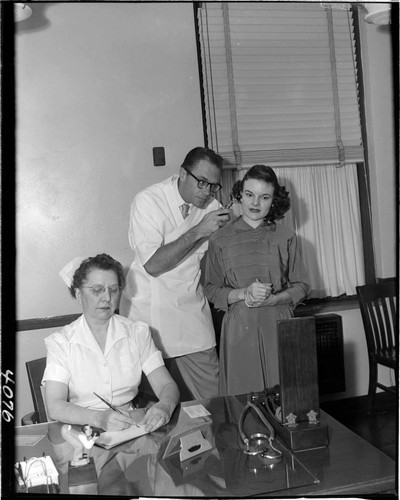 Young lady (new employee) getting medical check