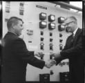 Men receiving certificates of completion for control room training