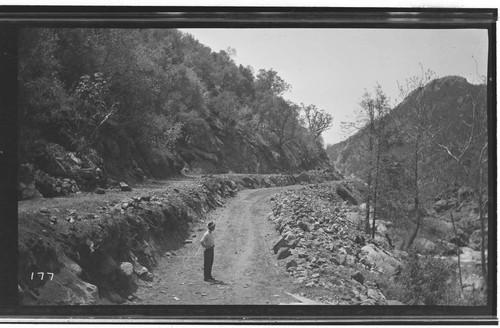 A man standing at Marble Fork at the Road #2 ditch excavation at Kaweah #3 Hydro Plant