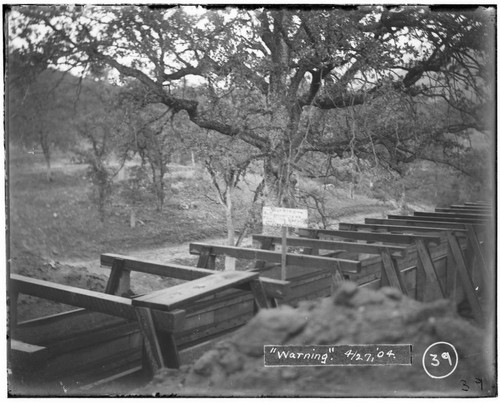 A warning sign that reads: "No trespassing on this ditch. Keep off CT Digger". The sign is on a flume at Kaweah #2 Hydro Plant