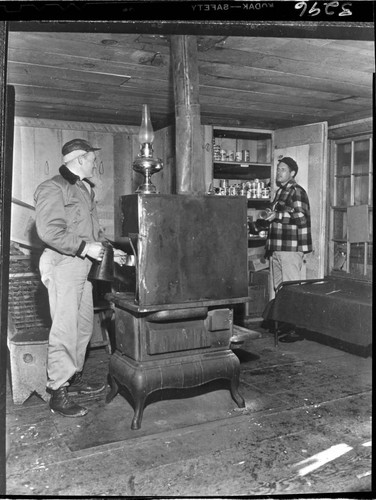 Two men in a shelter cabin at Kaiser Meadow used during snow surveys