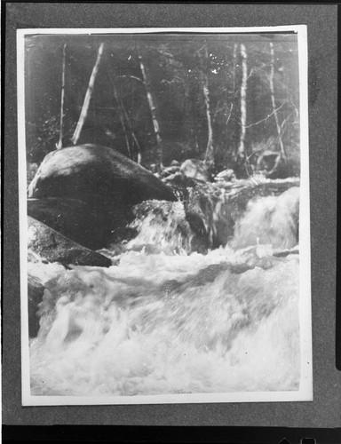 View of Mill Creek showing high water foaming over rocks