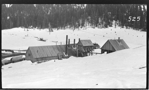 Several wooden buildings in a snow scene at Wolverton Reservoir