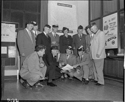 Men looking at document at meeting of American Legion