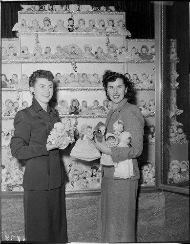 Two ladies with Christmas doll display