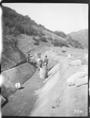 A construction crew plastering the ditch at the Tule Plant