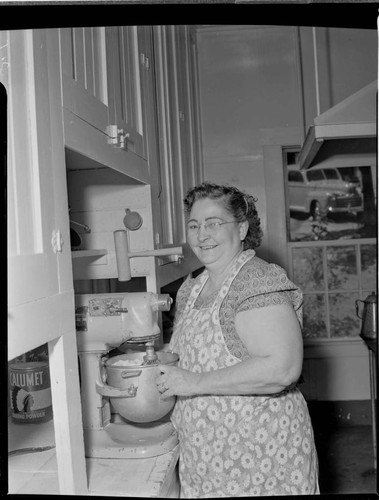 Woman mixing batter in kitchen at Big Creek