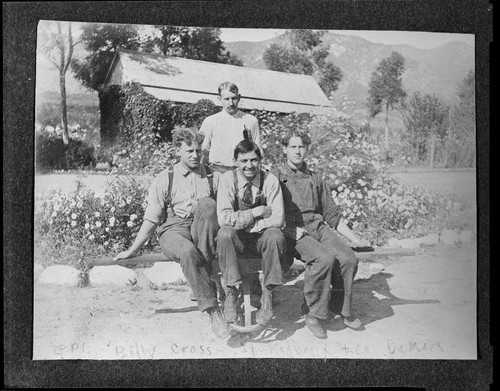 Four men of the operating crew sitting outside a company facility at Mill Creek #1 Hydro Plant. The men are E.P. Chase