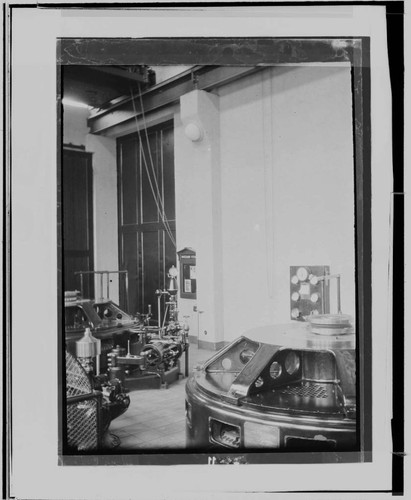 The interior of City of Los Angeles # ? Hydro Plant near Saugus. showing a sign near the door with safety bulletins and two low-