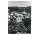 View of Montclair village in the Montclair district of Oakland, California, from the hills across Highway 13 which can be seen under construction in the midground