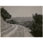 Car driving along a dirt road looking out over the valley near the present day Montclair district in Oakland, California