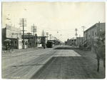 Electric street car approaching a stop on East 14th Street at 96th Avenue, looking east, in the Elmhurst district of Oakland, California