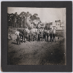 Employees of cement contractor Otto Schubert pose at a worksite in front of one of the company's cement mixers near Fruitvale Avenue and East 14th Street (later International Boulevard) in the Fruitvale district of Oakland, California