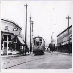 Electric streetcar heading south on 38th Avenue at Allendale Avenue in the Allendale district of Oakland, California. Allendale Theatre marquee in view