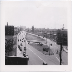Looking east along East 12th Street at 14th Avenue in the Clinton Park district of Oakland, California. Montgomery Ward distribution center in the background