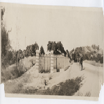 Two men walking down County Road 625 past a recently completed fence and gate at the future corner of Park Boulevard and St. James Drive in Oakland, California