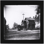 A family sits in their automobile on East 17th Street, looking west from Fruitvale Avenue in the Fruitvale district of Oakland California