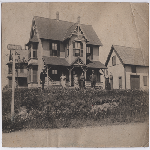 Men and women stand in front of a two-story home on Ford Street between Fruitvale and 29th Avenues the Kennedy Tract, Oakland, California