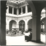 Interior courtyard of the YWCA building in Oakland, California, showing chairs and potted plants