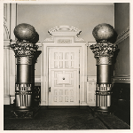 Interior hallway of Live Oak Lodge at 12th and Washington Streets in Oakland, California, showing ornate pillars topped by globes