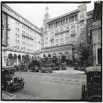 Exterior of Hotel Oakland in Oakland, California, showing driveway along 13th Street with parked cars in front