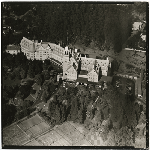 Aerial view of Claremont Hotel in Oakland, California, showing tennis courts in foreground