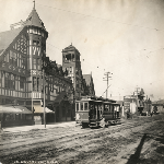 Key Route Inn on Broadway in Oakland, California, showing passenger boarding a 7th Street streetcar