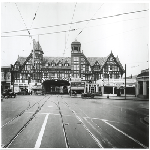 Front view of Key Route Inn on Broadway in Oakland, California, showing streetcar running through hotel