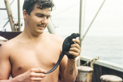 Shellback Expedition - Galapagos Islands - Robert Gilkey with Marine Iguana From Rocky Galapagos Shore