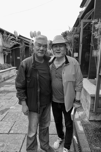 Liu Jiaoxin and Huo Feng outside of local Bai restaurant