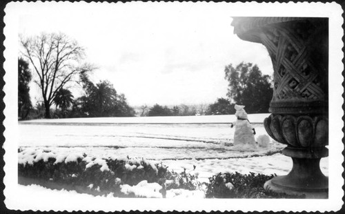 Snowman and east lawn after snowfall, February 1948